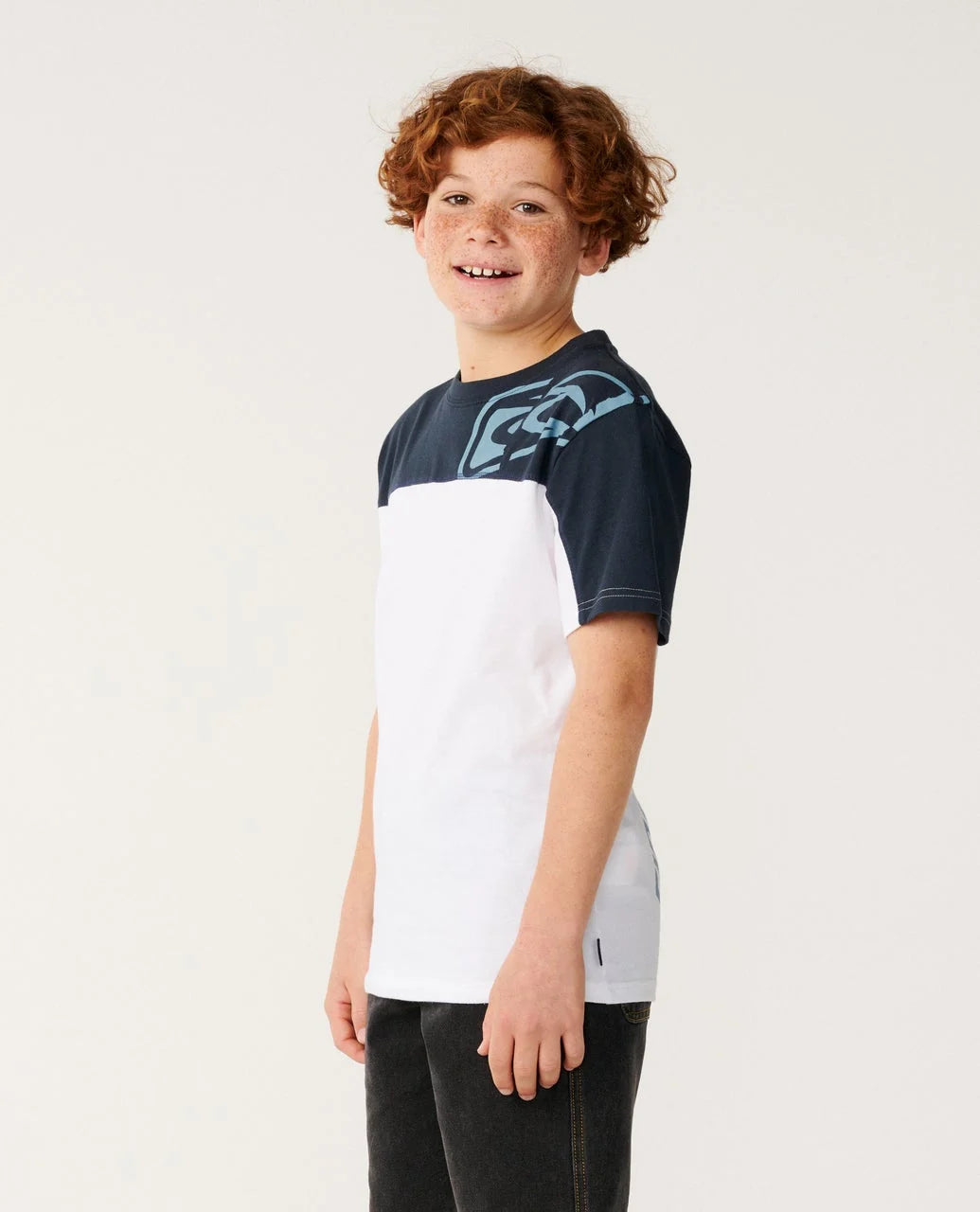 Child wearing a navy and white t-shirt with a graphic design on a plain background