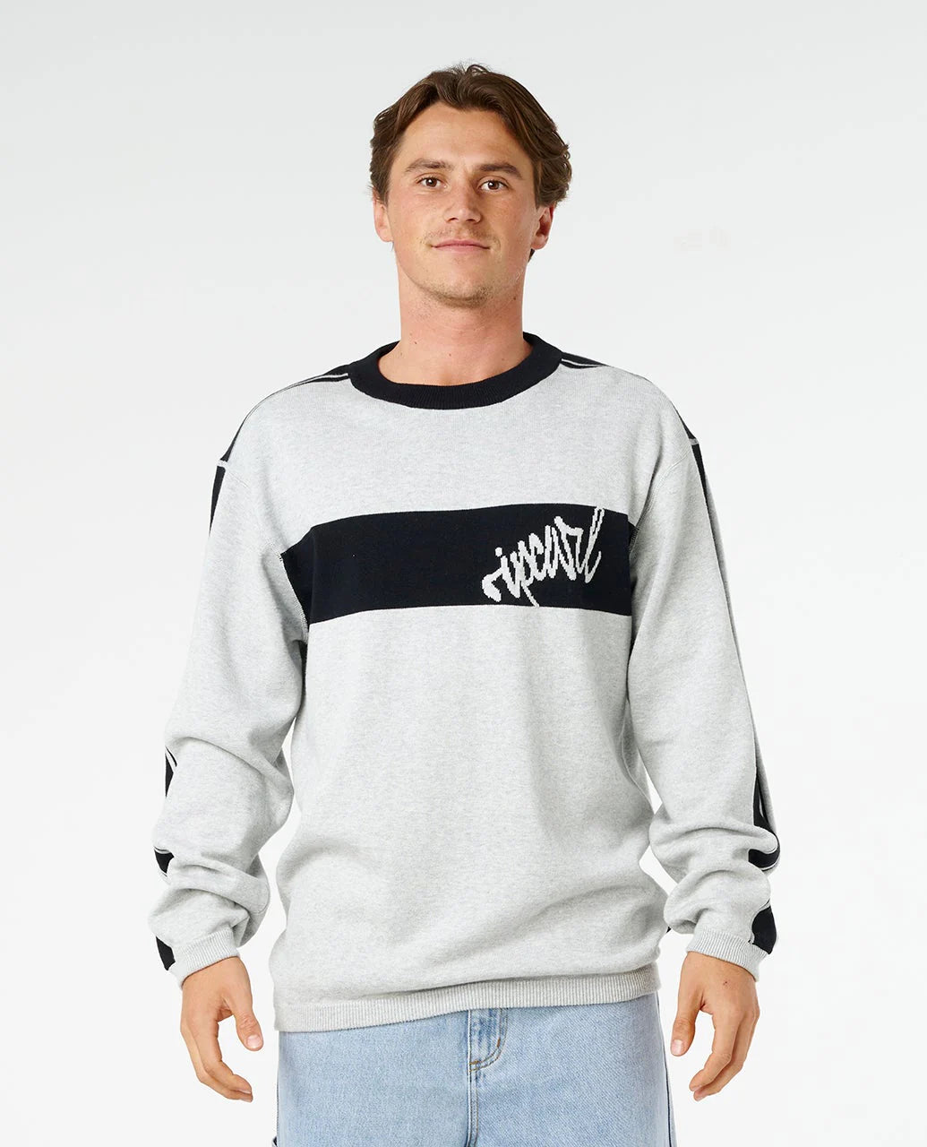 Man wearing a gray sweater with a black stripe and logo on a white background