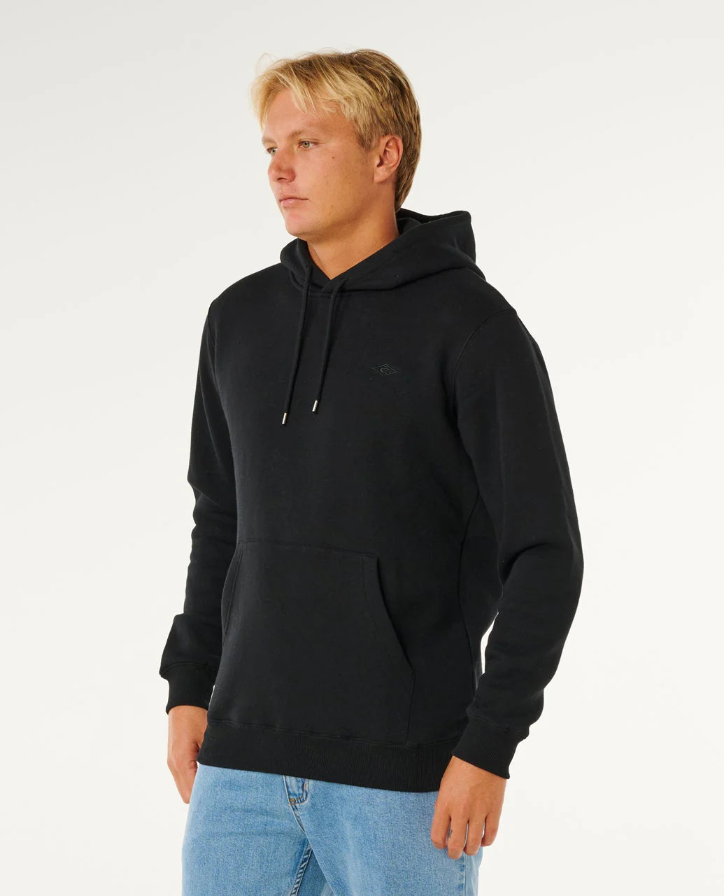 Person wearing a black hoodie and light blue jeans on a white background