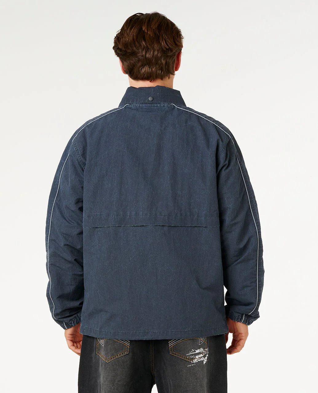 Person wearing a blue denim jacket on a white background