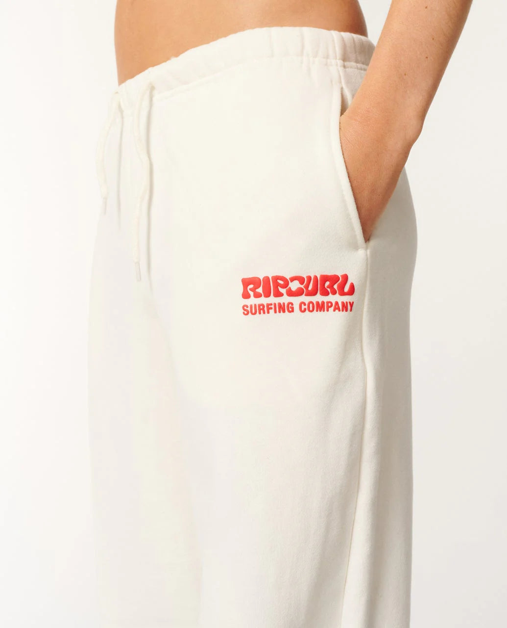 White sweatpants with red Rip Curl logo on a white background