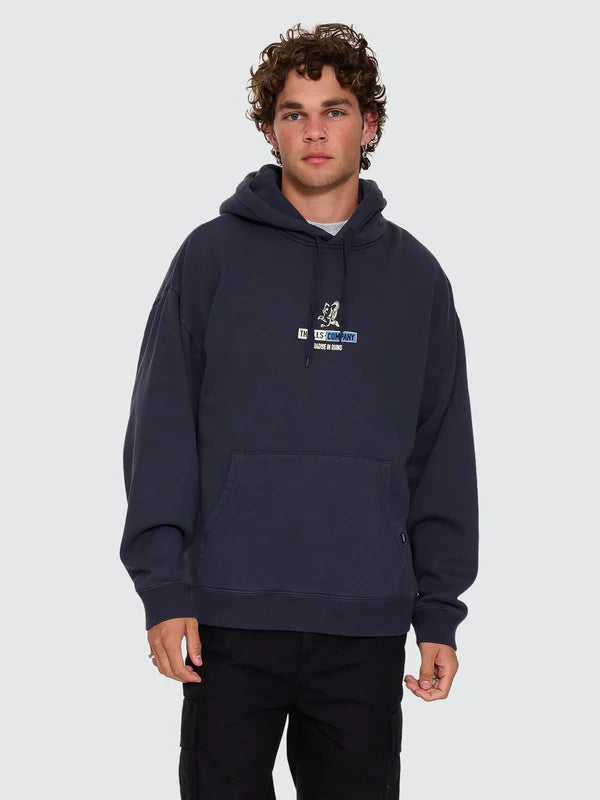 Person wearing a navy hoodie with a thrills company logo on a white background