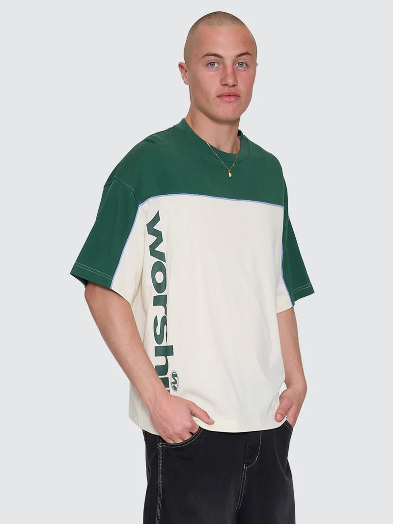 Man wearing a green and white shirt with 'Woolrich' branding on a plain background