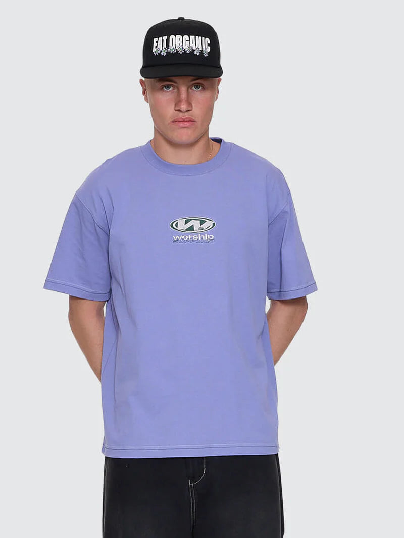 Person wearing a purple t-shirt with a logo and a black cap with text on a white background