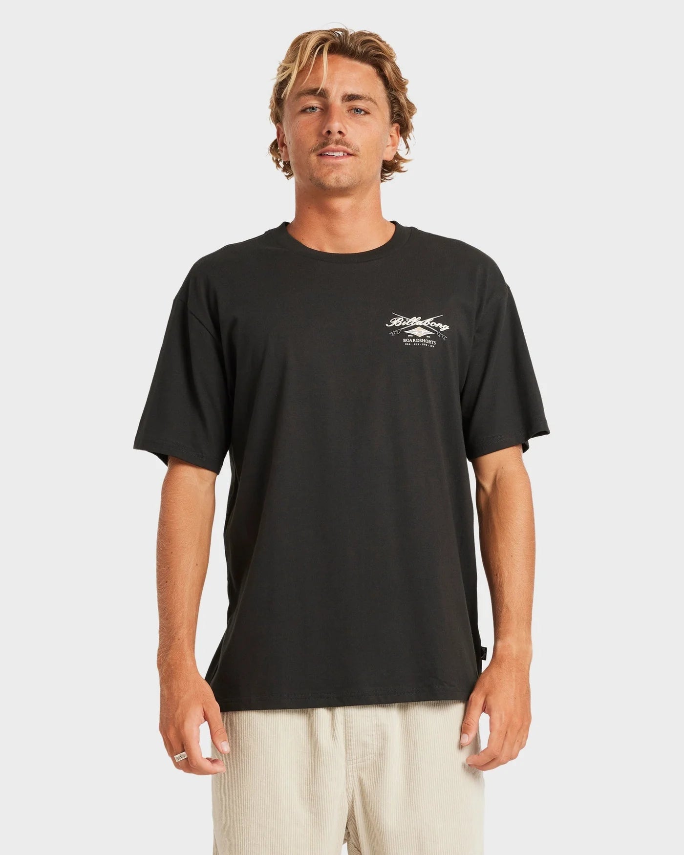 Man wearing a black t-shirt with a logo on a white background