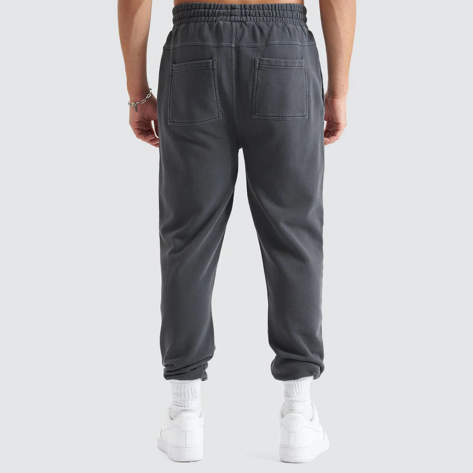 Person wearing gray sweatpants on a white background