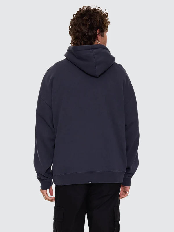 Person wearing a dark blue hoodie from behind on a light gray background