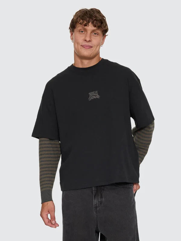 Man wearing a black long-sleeve shirt with a logo on a white background