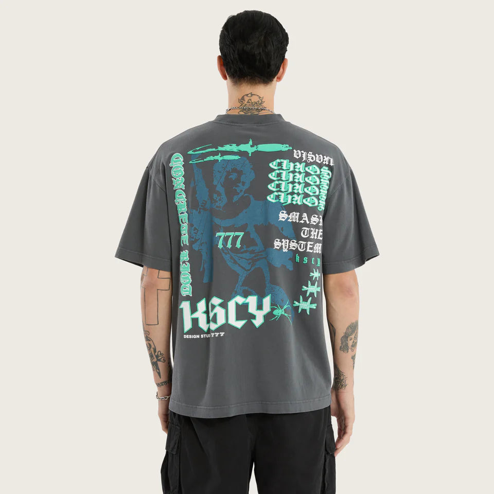 Person wearing a gray t-shirt with graphic designs on the back, standing against a white background