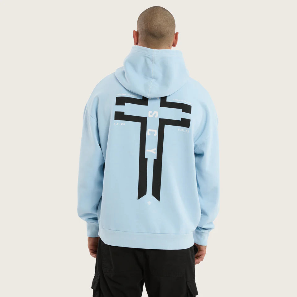 Person wearing a light blue hoodie with a black logo on the back against a white background