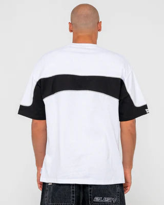 Person wearing a white and black color-blocked t-shirt on a plain background