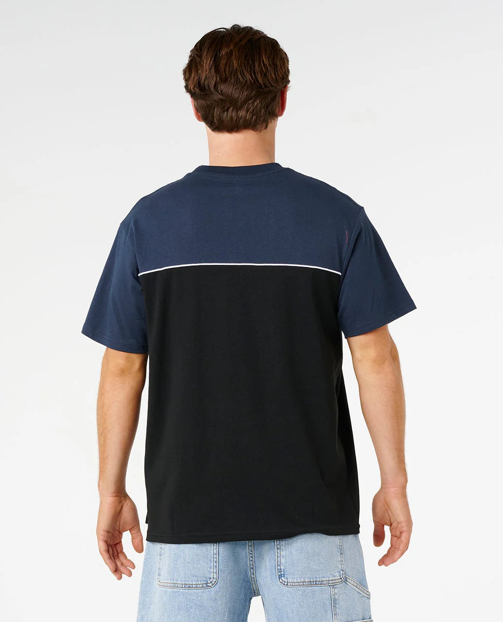 Person wearing a navy and black t-shirt with a white stripe on a light gray background