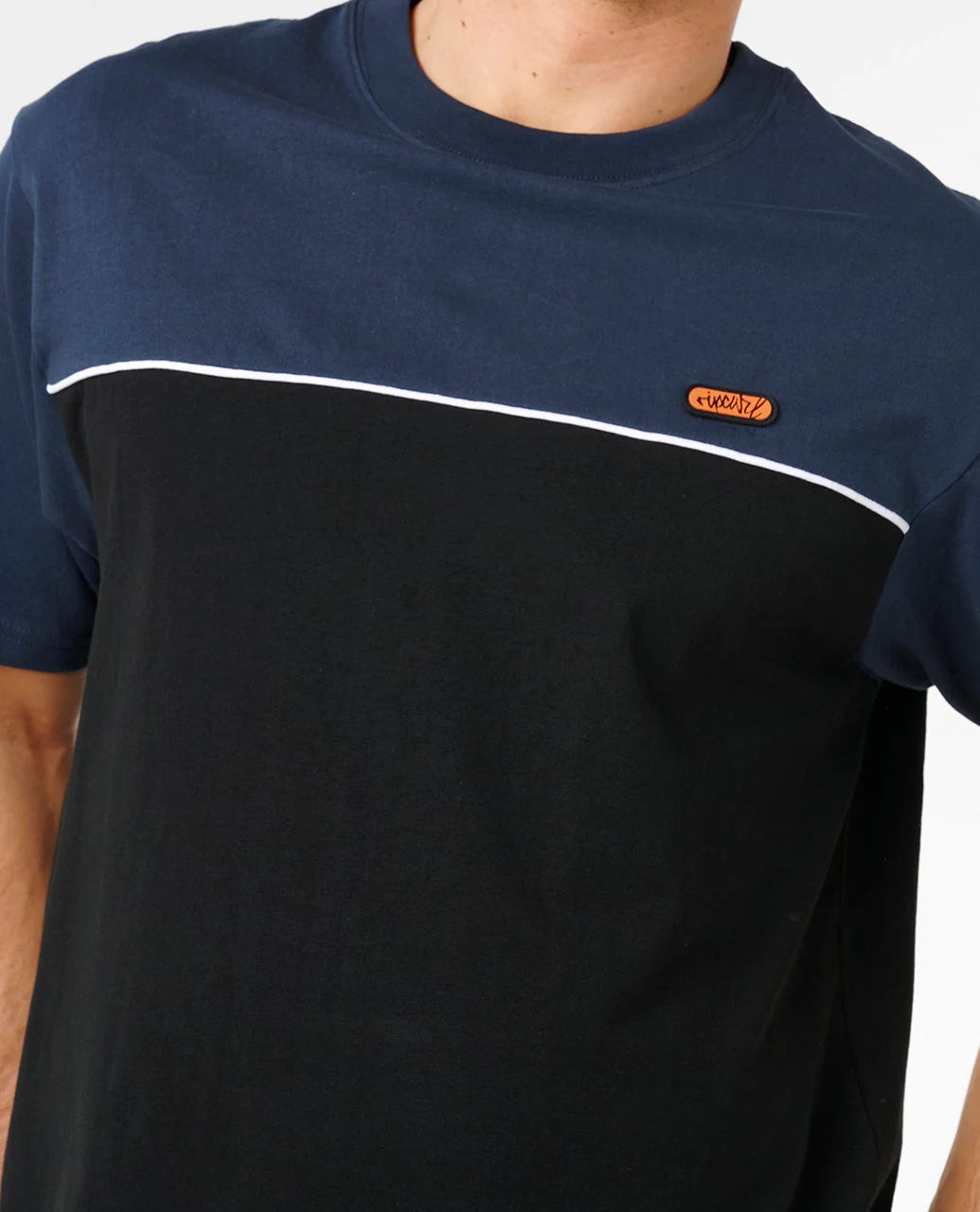 Two-tone navy and black t-shirt with a small logo on a white background