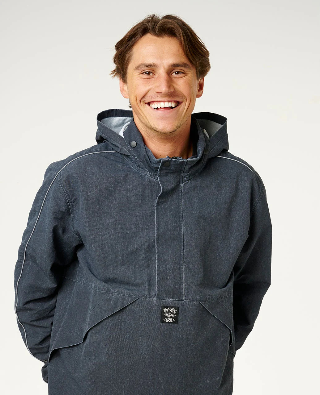 Man wearing a dark blue raincoat against a white background