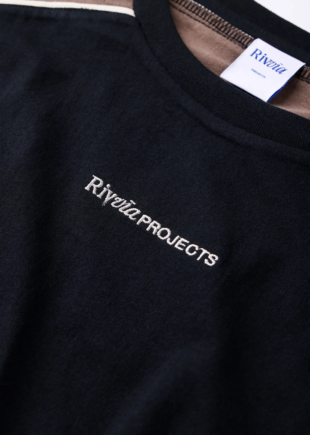 Black sweatshirt with 'Riviera Projects' embroidery on a plain background