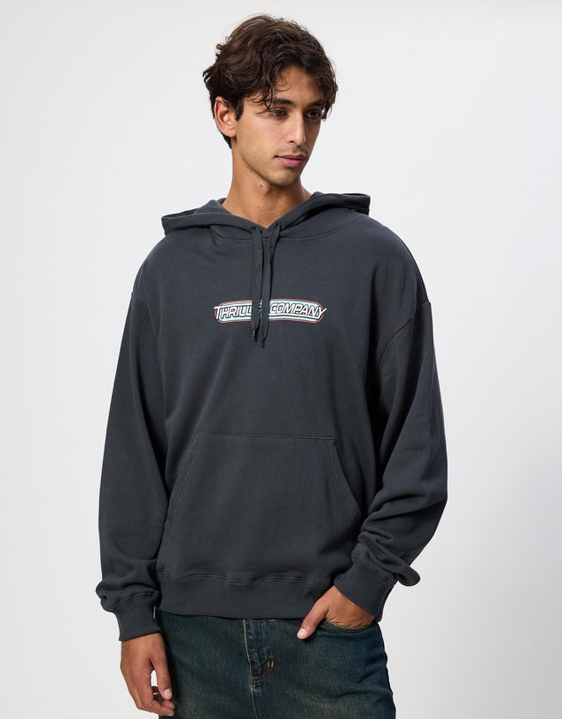 Person wearing a dark gray hoodie with a logo on a white background