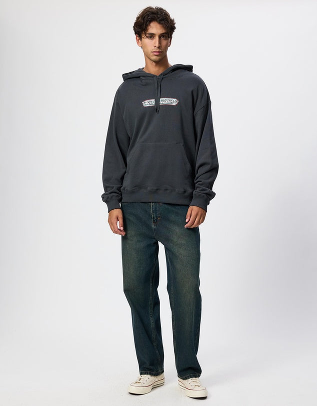 Man wearing a dark gray hoodie and jeans on a white background
