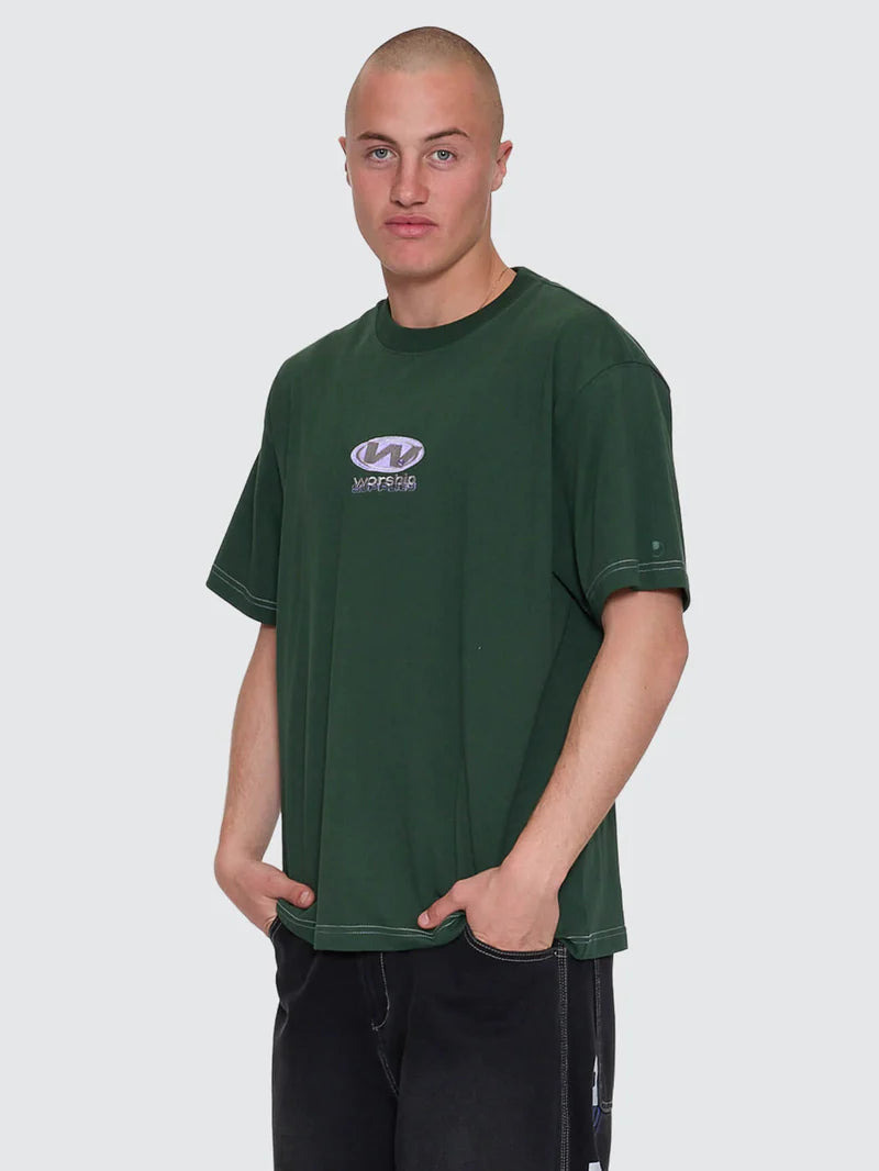 Man wearing a green t-shirt with a logo on a plain background