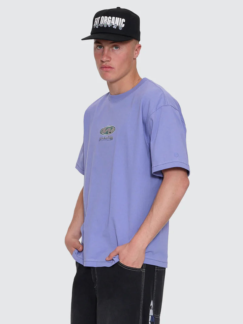 Person wearing a purple t-shirt and black cap with text on a light gray background