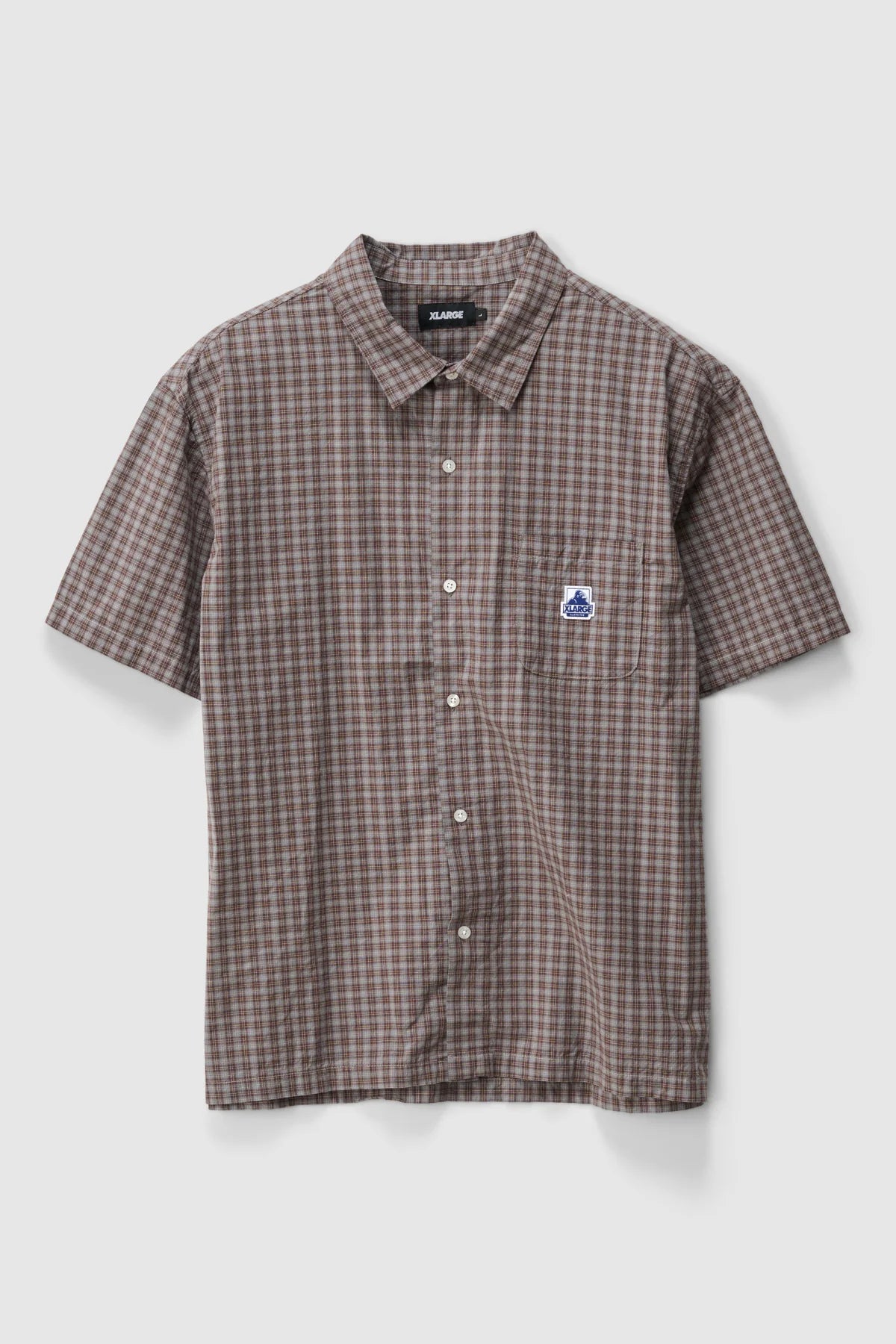 Checkered shirt with a small XLarge logo on a light gray background