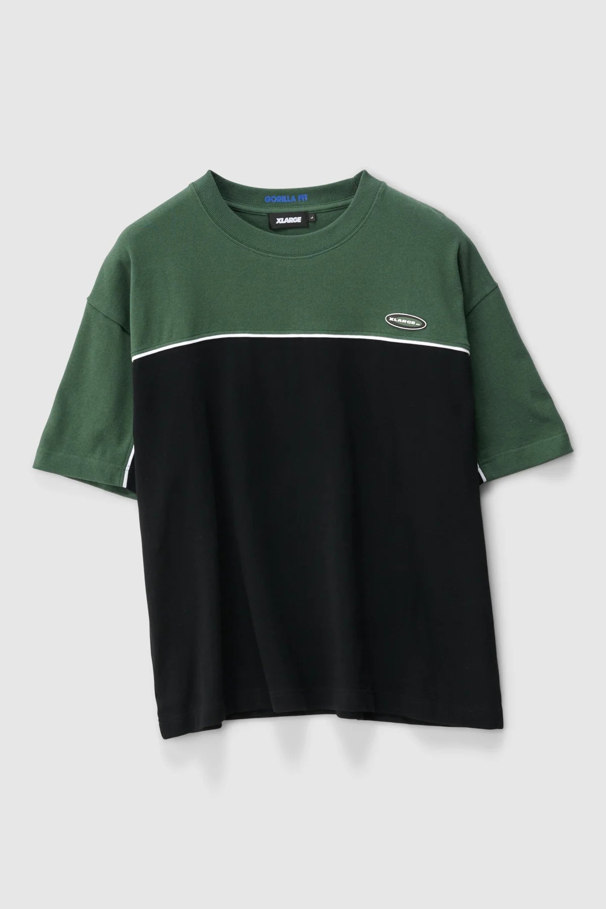 Green and black color-blocked t-shirt with a brand logo on a light gray background