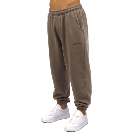 Brown sweatpants with a brand logo on a white background