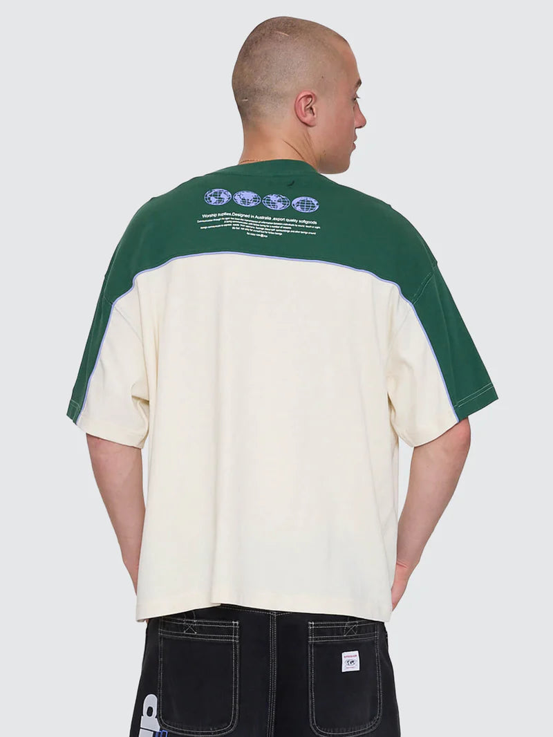Person wearing a green and beige color-blocked t-shirt with text on the back against a white background